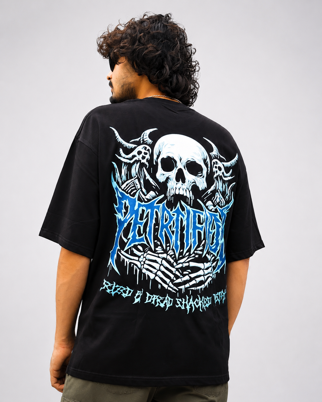 Back view of black streetwear tee featuring horned demon skull and cyan blue metal typography back graphic.