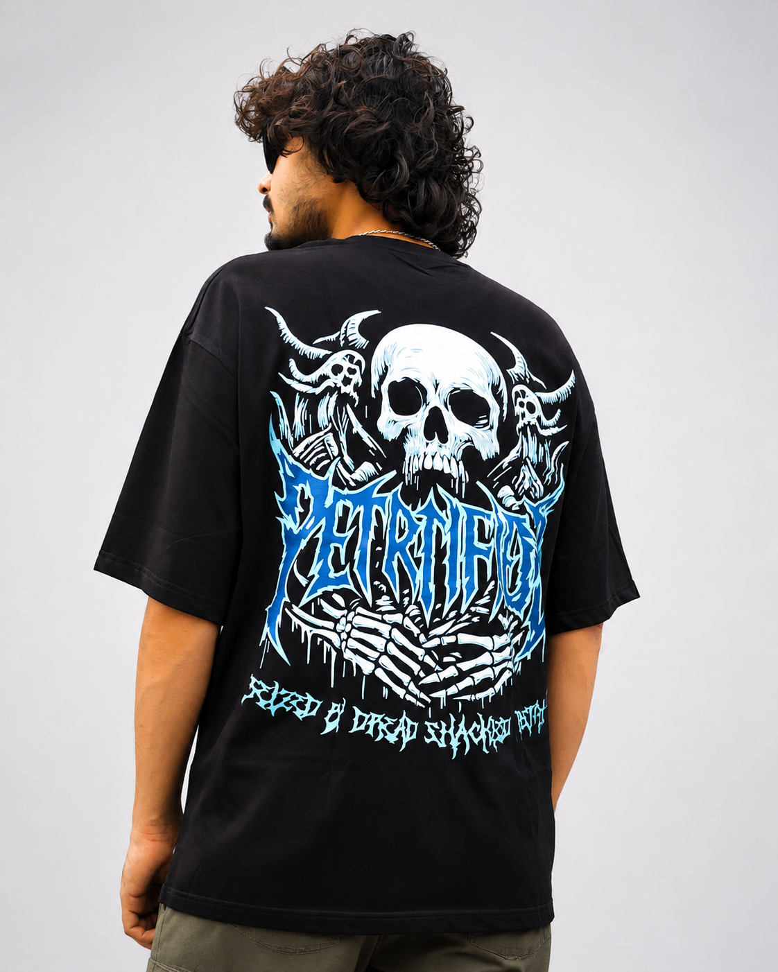 Back view of black streetwear tee featuring horned demon skull and cyan blue metal typography back graphic.
