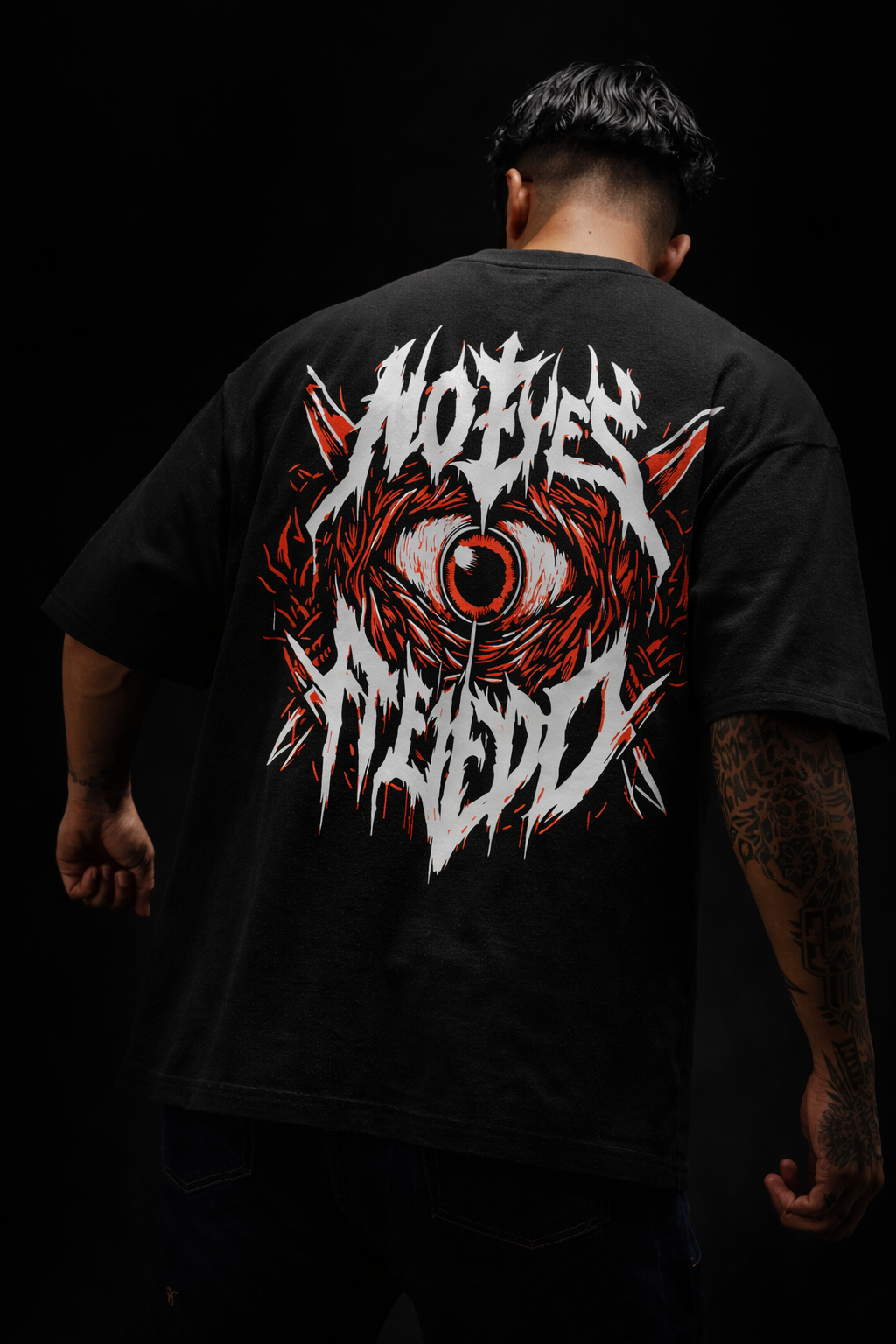 Back view of black streetwear tee featuring red demonic eye graphic and No Eyes Fien metal typography on model.
