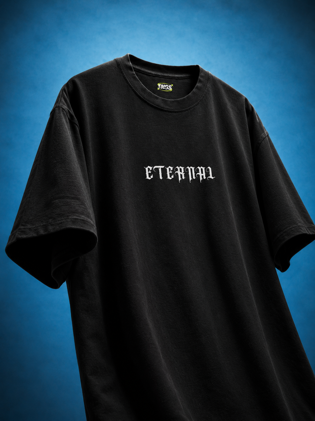 Front floating view of TNGS black oversized drop shoulder t-shirt with white gothic Old English Eternal chest logo.
