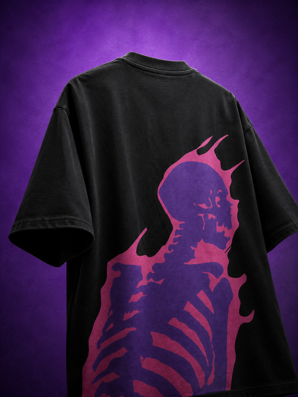 Back angle view of black oversized streetwear t-shirt featuring vibrant purple flaming skeleton skull graphic print.