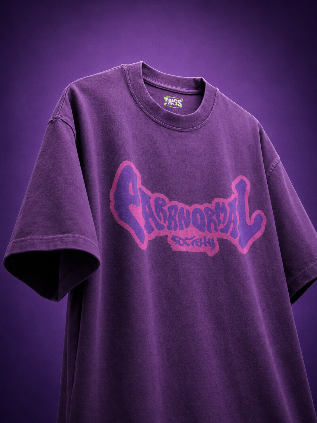 Front view of TNGS Clothing Paranormal Society purple oversized drop shoulder t-shirt with purple front typography logo.